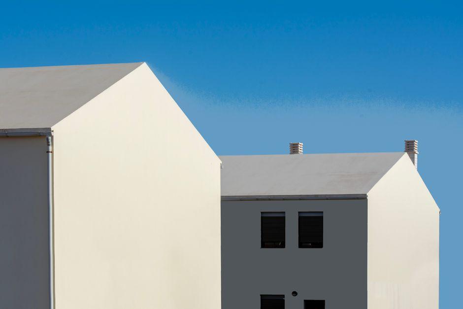 Two White Houses with Blue Sky in the Background